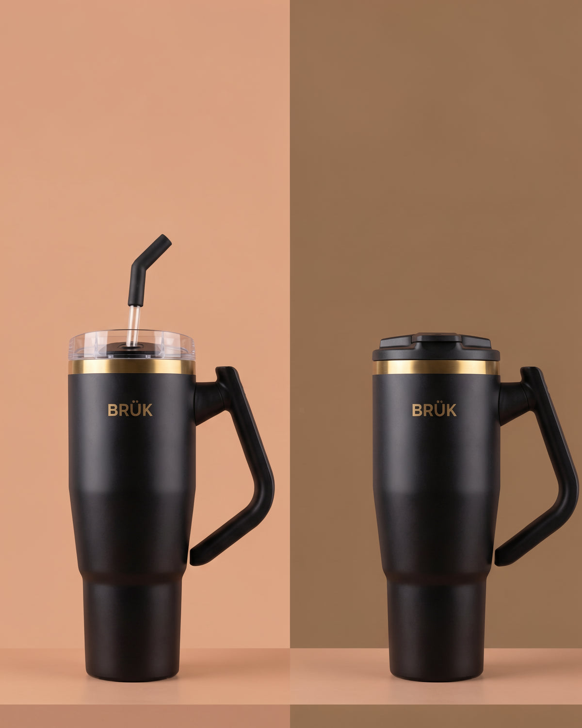 Two matte black BRÜK travel tumblers with handles are shown on a split beige and brown background. The left tumbler has a clear lid with a black straw, and the right tumbler has a black lid.